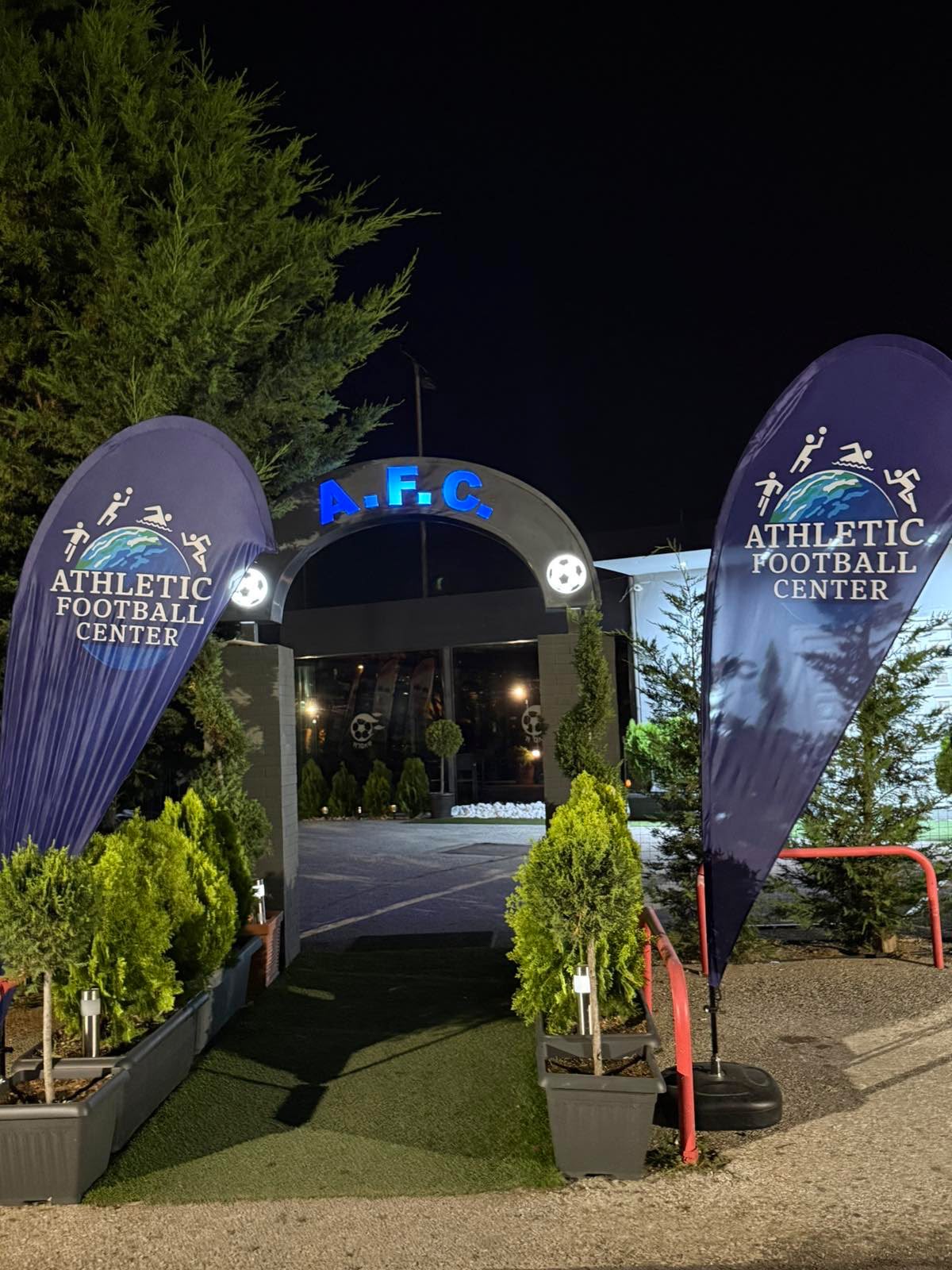 Main gate at night, lit blue