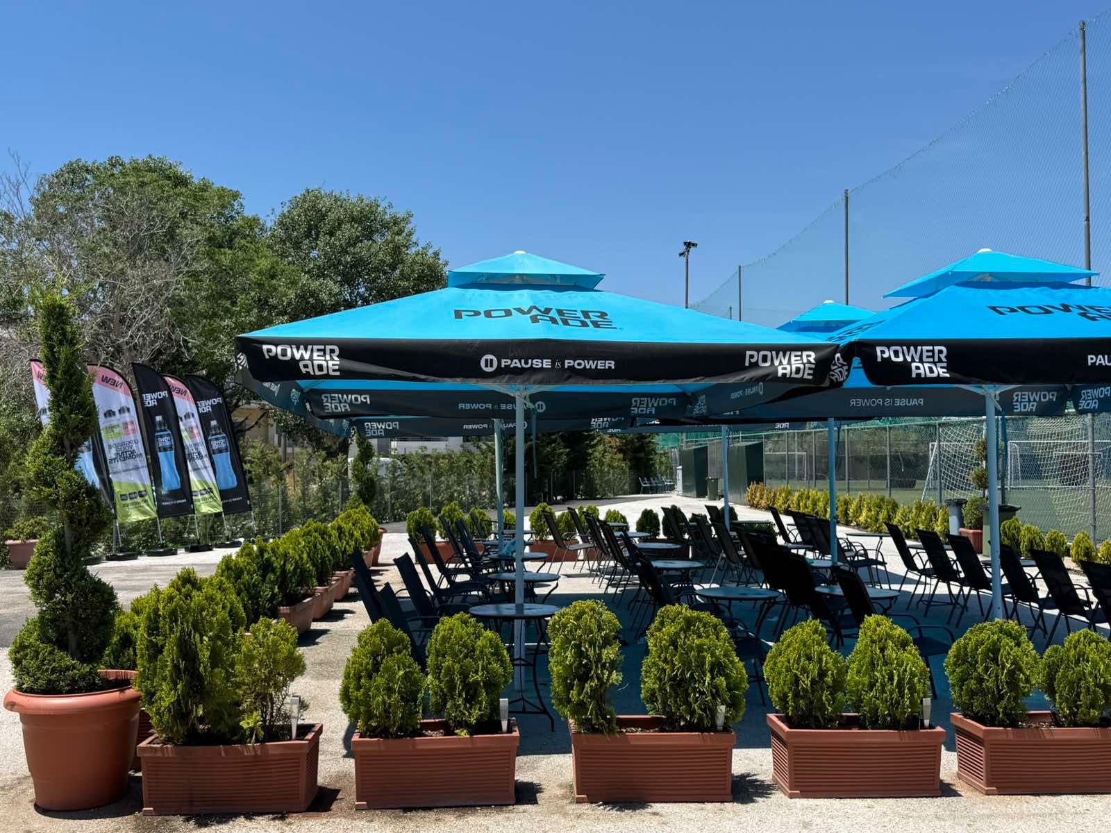 Café terrace, shaded seating between the courts